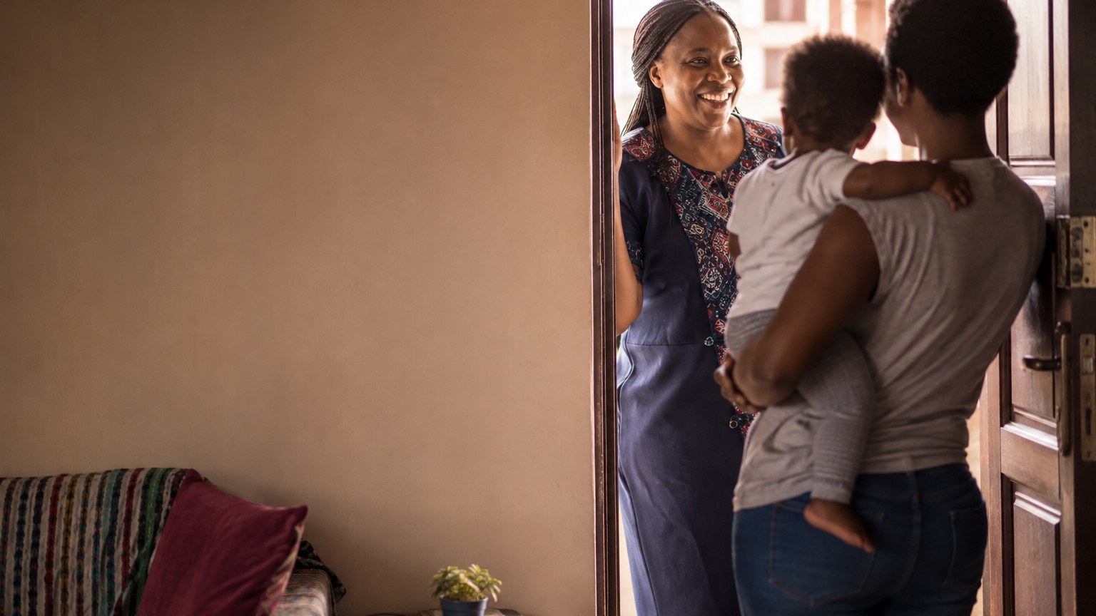 A house manager welcoming a family in a Nairobi home
