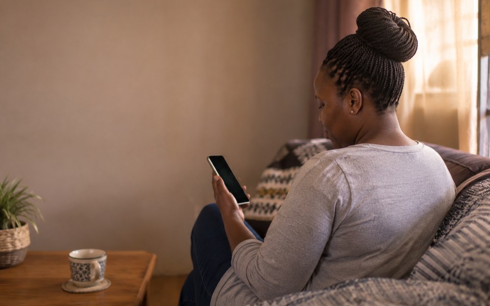 A woman browsing house manager profiles on her phone